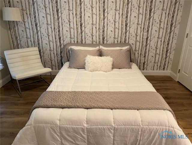 bedroom with dark wood-type flooring