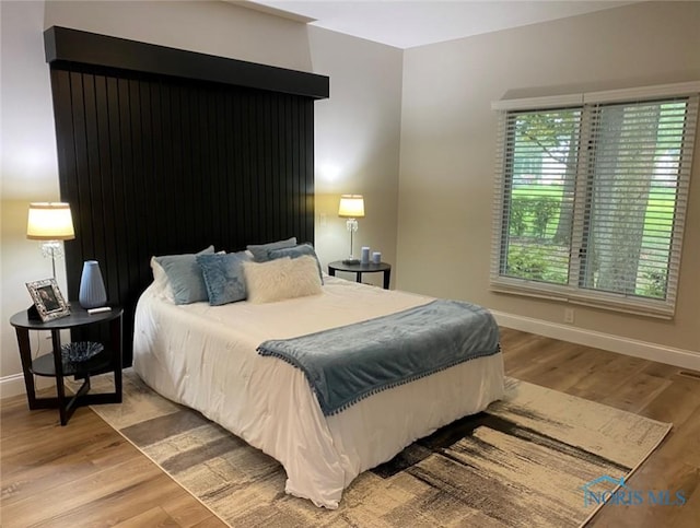 bedroom with hardwood / wood-style flooring