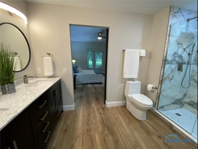 bathroom featuring toilet, an enclosed shower, vanity, hardwood / wood-style flooring, and ceiling fan