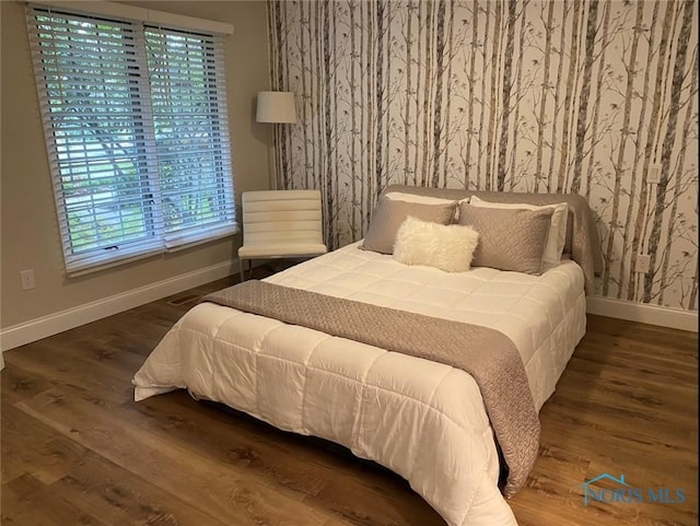 bedroom with dark wood-type flooring