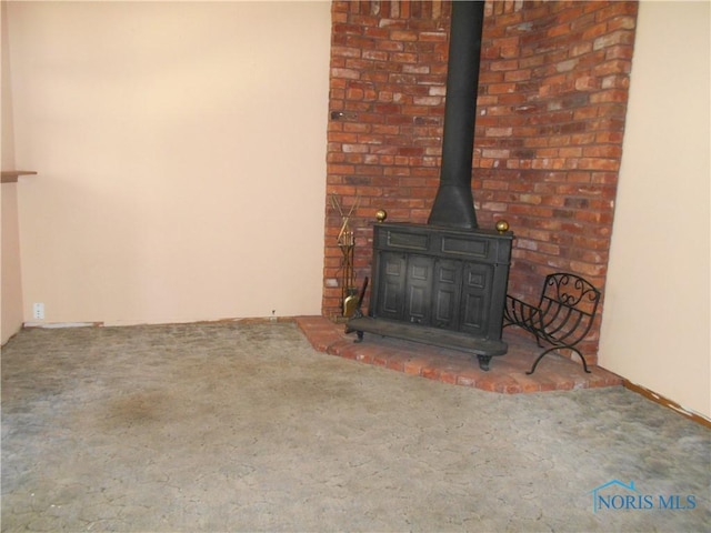 room details featuring carpet floors and a wood stove