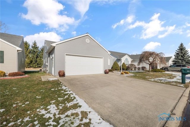 view of front of home with a garage and a front lawn