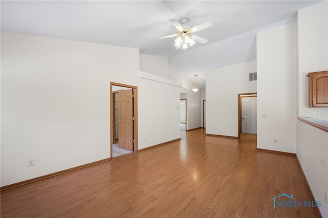 spare room featuring high vaulted ceiling, light hardwood / wood-style floors, and ceiling fan