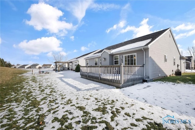 snow covered property with a deck