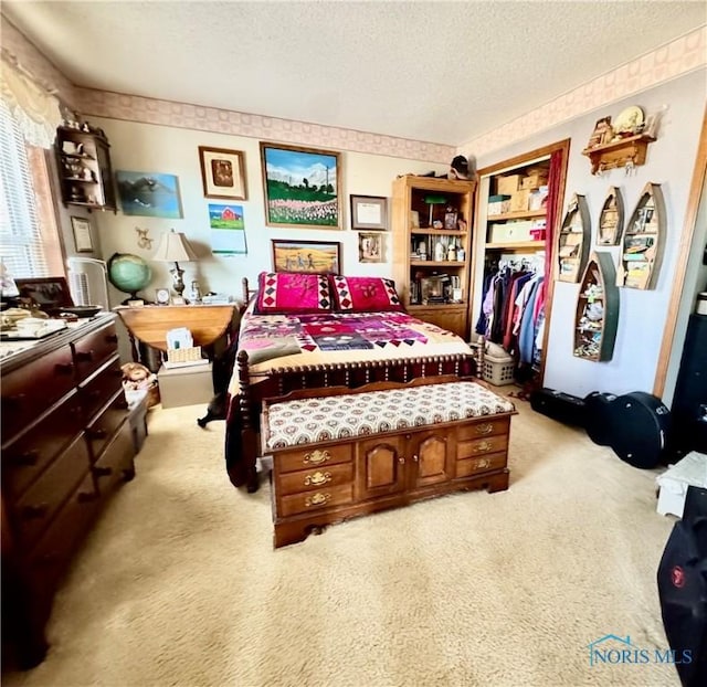 bedroom featuring light colored carpet and a textured ceiling