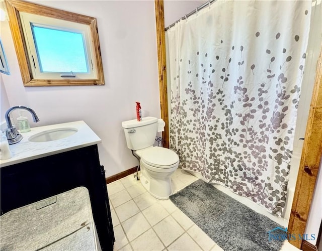 bathroom with vanity, tile patterned flooring, and toilet