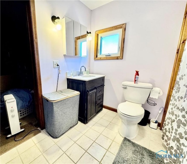 bathroom featuring tile patterned flooring, vanity, and toilet