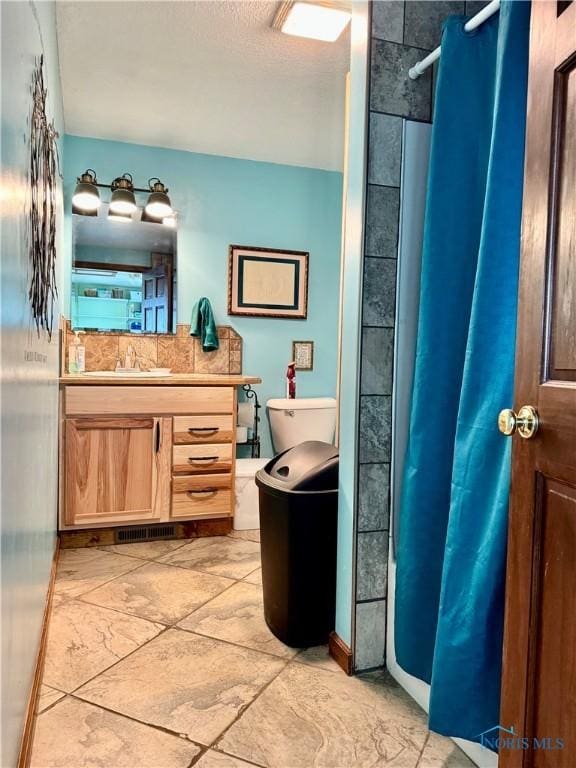 bathroom featuring vanity and a shower with shower curtain