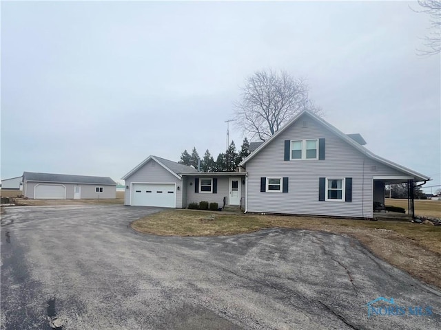 view of front of home with a garage and a carport