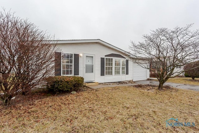 view of property exterior featuring a garage and a yard