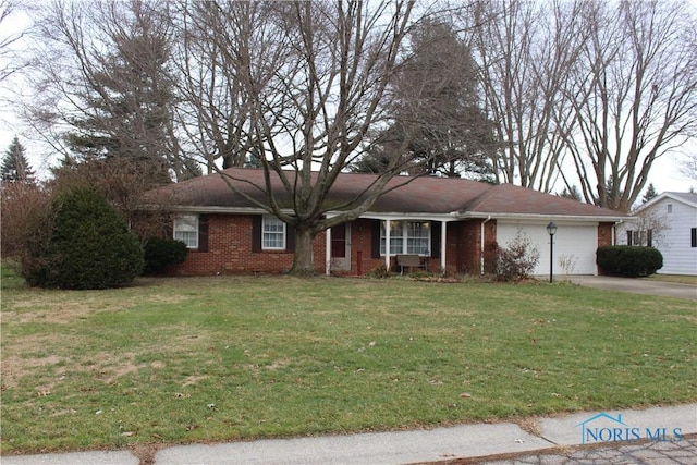 ranch-style house featuring a garage and a front lawn