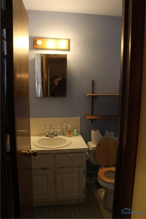 bathroom featuring vanity and toilet