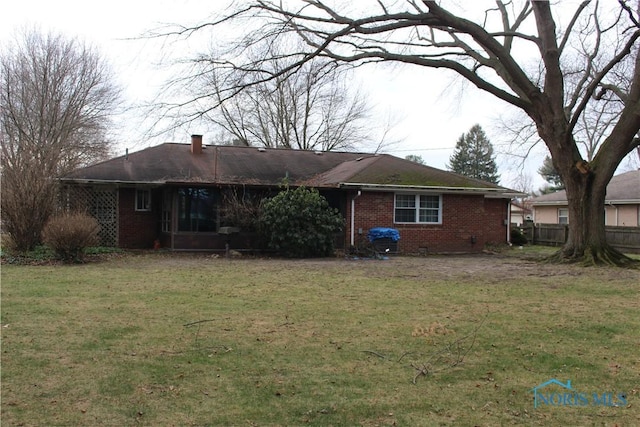 rear view of house with a lawn