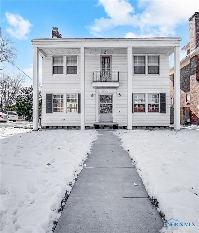 view of front of home with a balcony