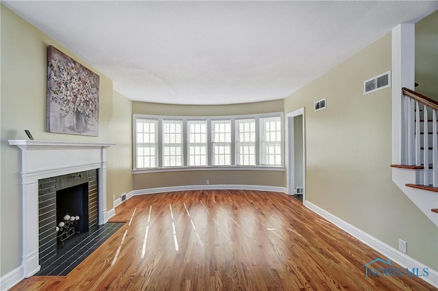 unfurnished living room with hardwood / wood-style floors