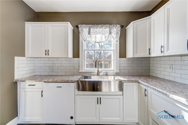 kitchen featuring white cabinetry, white dishwasher, and sink