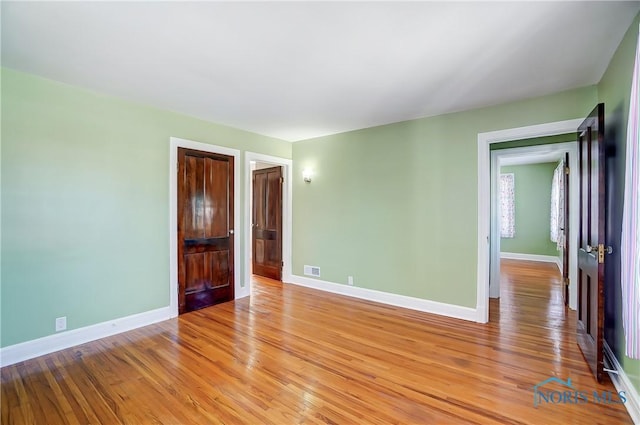 unfurnished room with light hardwood / wood-style flooring