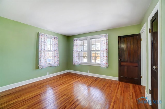 spare room with wood-type flooring