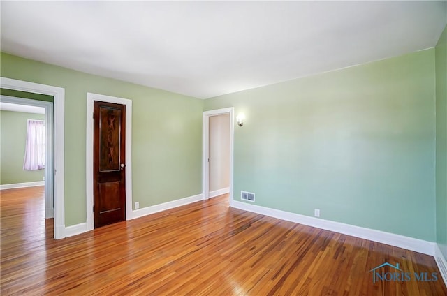 empty room with light hardwood / wood-style flooring