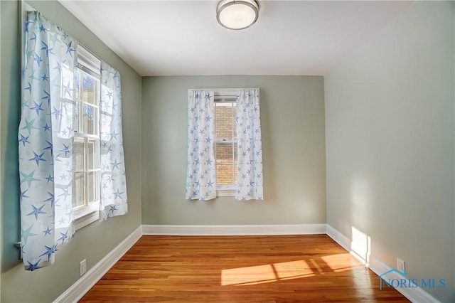 spare room with wood-type flooring