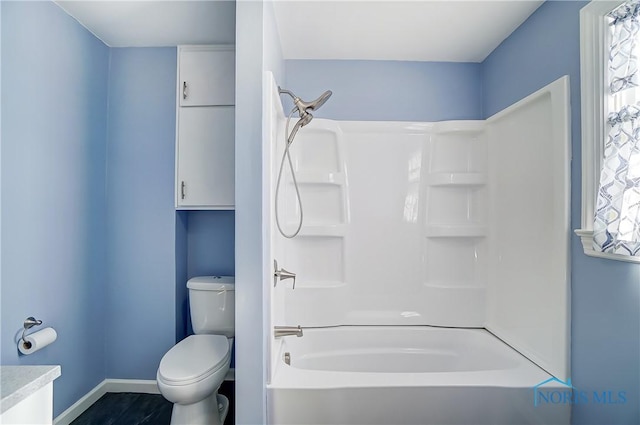 bathroom featuring toilet and shower / bath combination