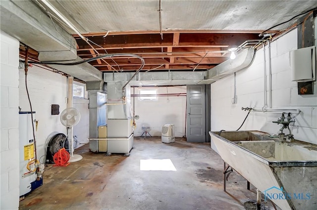 basement featuring heating unit, sink, and gas water heater