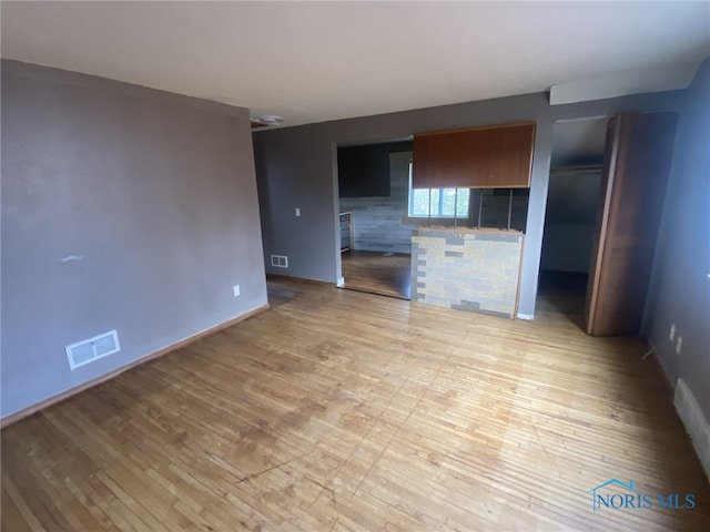 unfurnished living room featuring light hardwood / wood-style floors