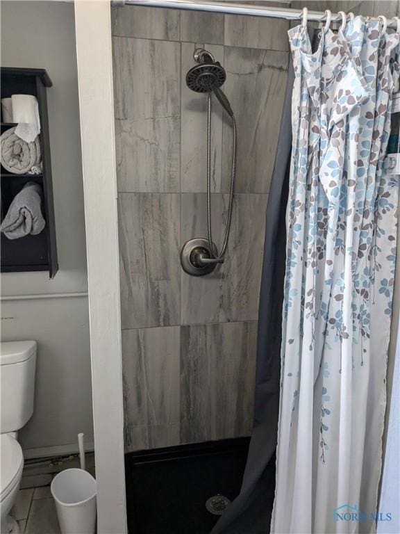 bathroom with toilet and walk in shower