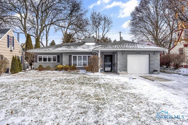 ranch-style house with cooling unit and a garage