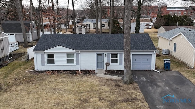 single story home with a garage and a front yard