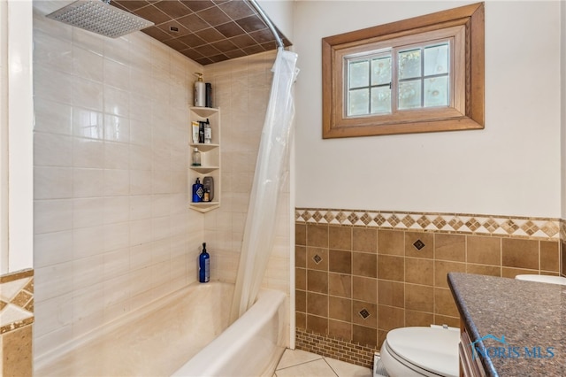 full bathroom with tile walls, tile patterned flooring, vanity, toilet, and shower / bath combo with shower curtain