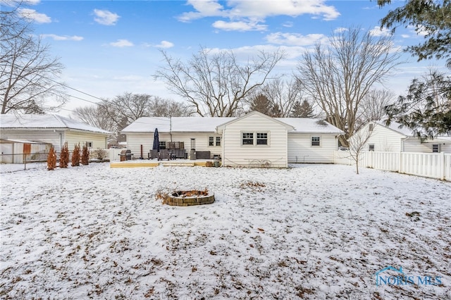 view of snow covered rear of property