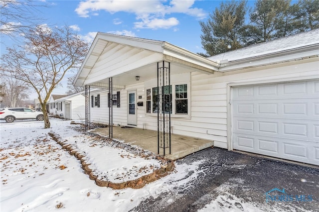 view of front facade with a garage and a porch