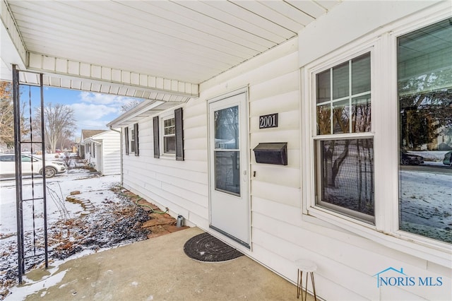 view of snow covered property entrance