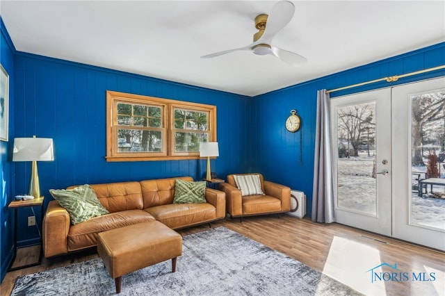 living room featuring ceiling fan, hardwood / wood-style flooring, french doors, and a healthy amount of sunlight