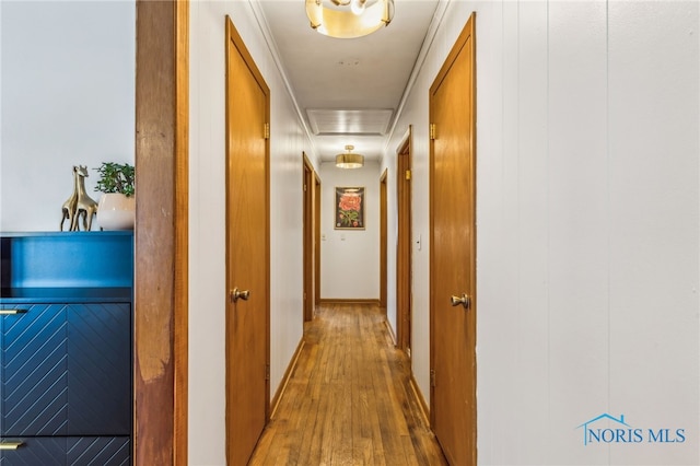 corridor with hardwood / wood-style flooring