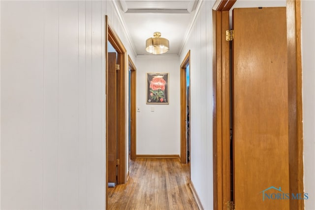 hall with crown molding and light hardwood / wood-style floors