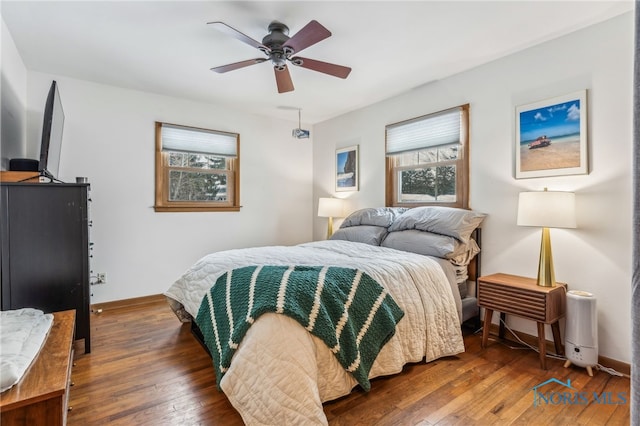 bedroom featuring dark wood-type flooring and ceiling fan