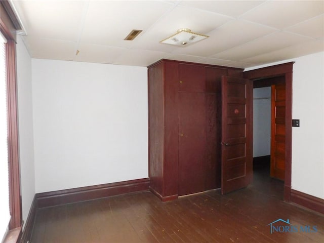 unfurnished room featuring dark hardwood / wood-style floors