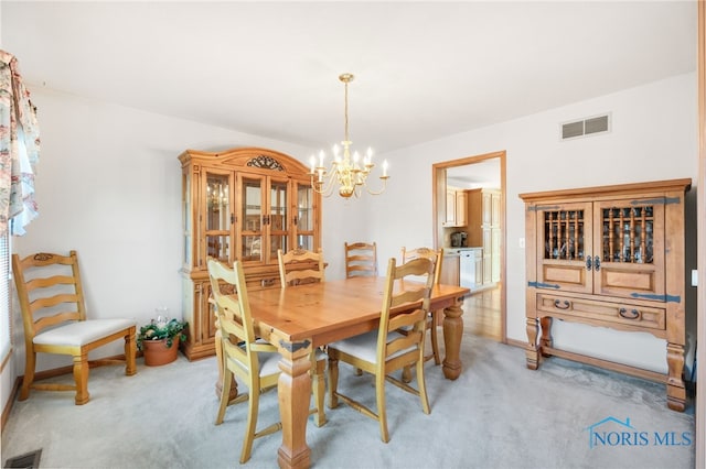 dining room featuring a notable chandelier and light colored carpet