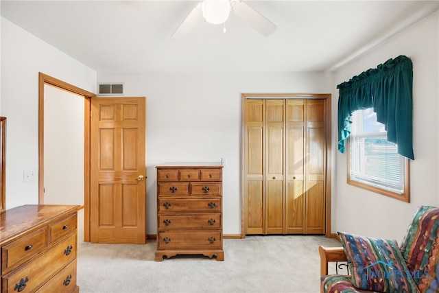 bedroom with light colored carpet, a closet, and ceiling fan