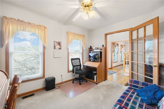 office space featuring carpet floors, a wealth of natural light, and ceiling fan