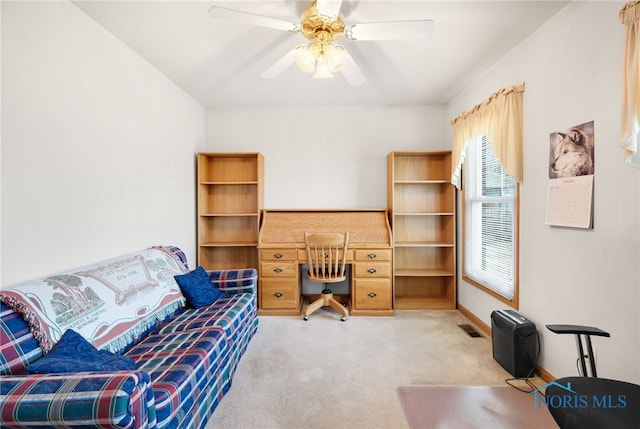 carpeted office space with ceiling fan