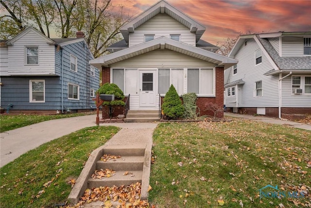 view of front of house featuring a yard and cooling unit