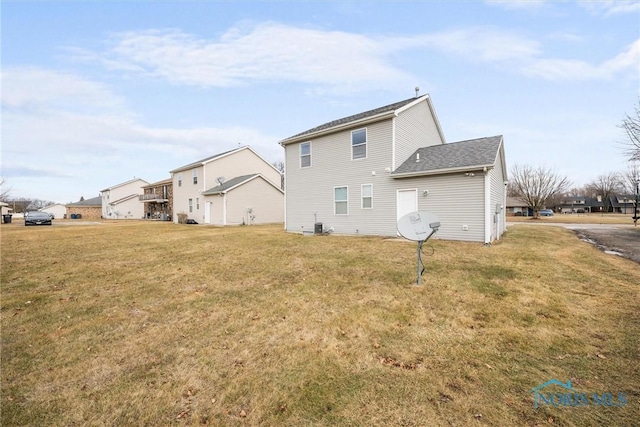 rear view of house featuring a lawn