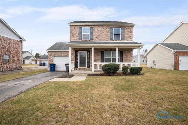 front of property featuring a garage, covered porch, and a front yard