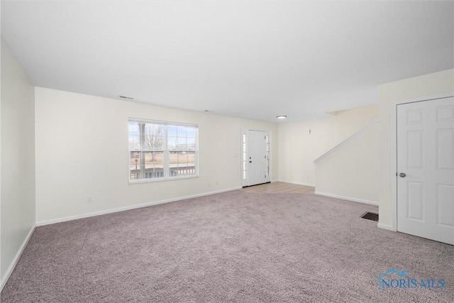 spare room with light colored carpet