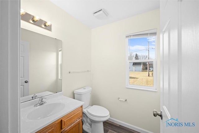 bathroom featuring hardwood / wood-style flooring, vanity, and toilet