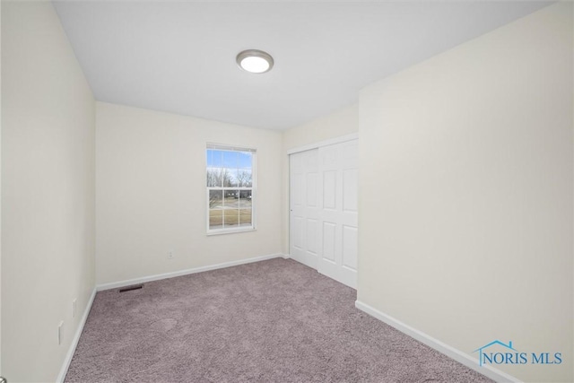 unfurnished room with light colored carpet