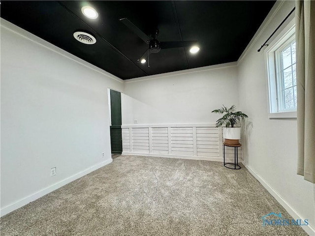 unfurnished room featuring ceiling fan, ornamental molding, and carpet flooring